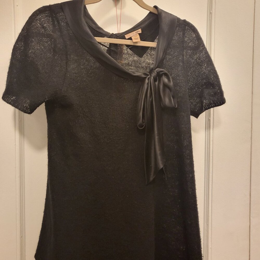 Sheer knit top with silk bow and buttons on back